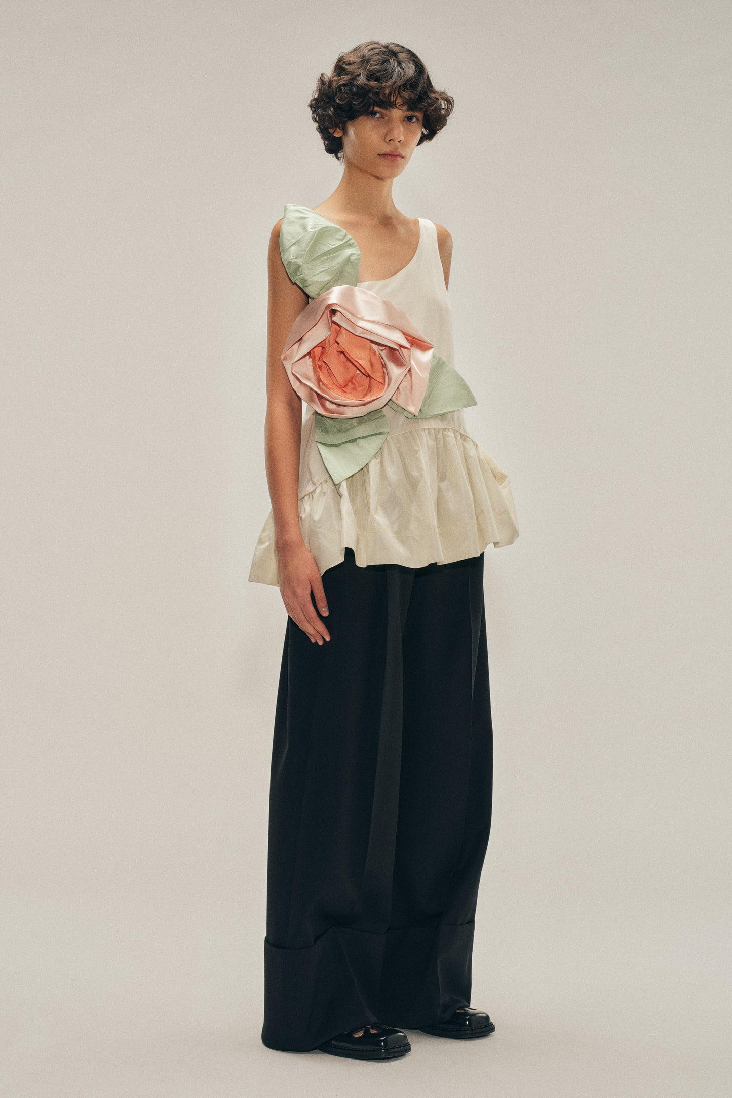 Pressed Rosette Tilted Neck Peplum Top